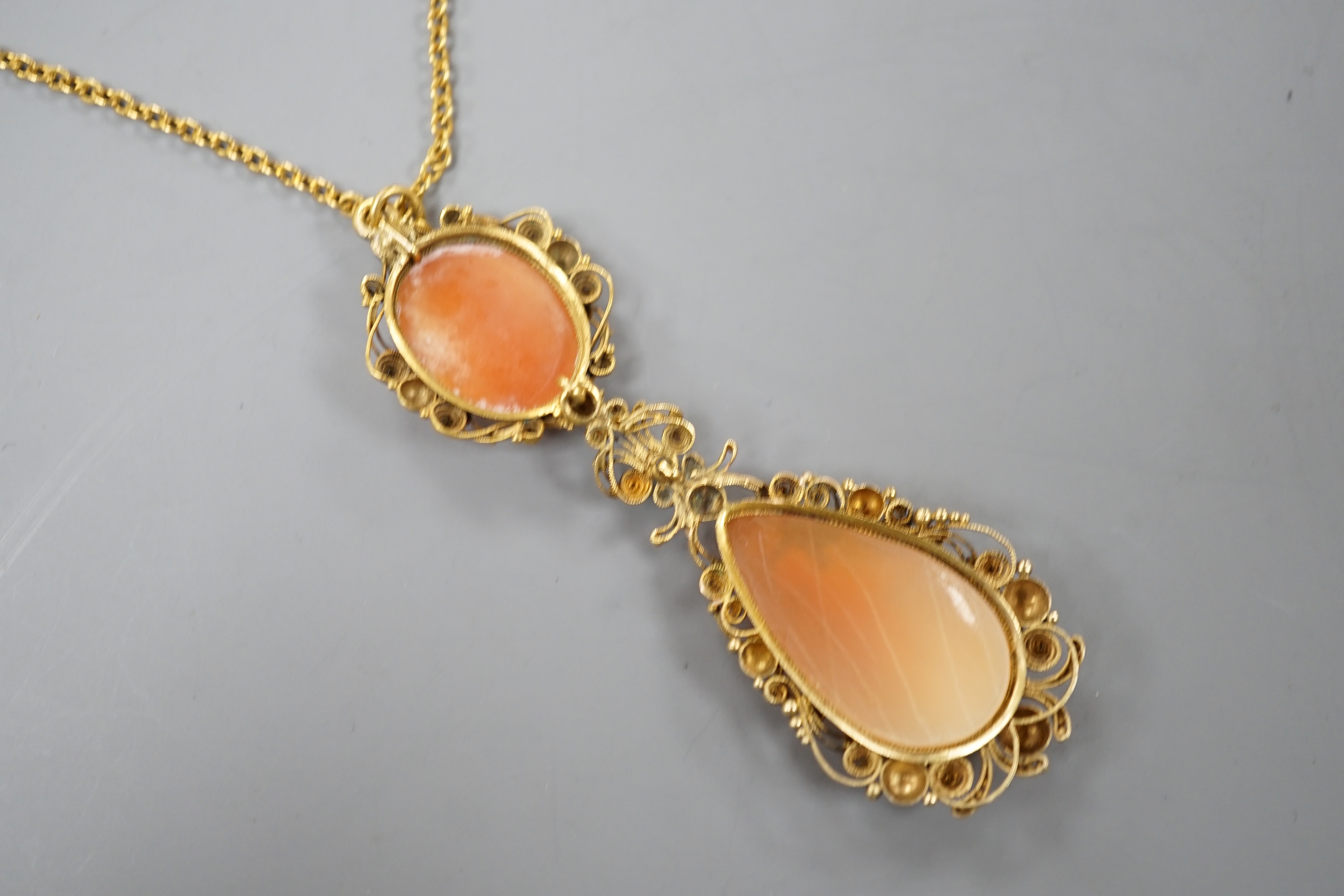A 9ct and cameo shell set drop pendant necklace, 70cm, gross weight 10.9 grams.